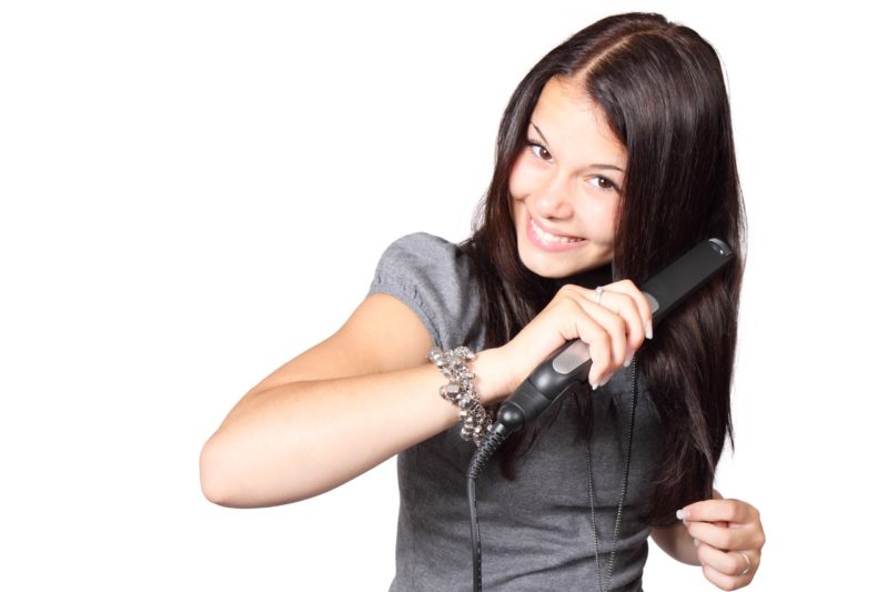 women using hair flat irons